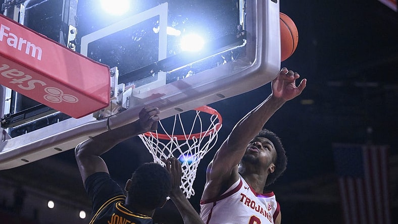 Dec 10, 2023; Los Angeles, California, USA; USC Trojans guard Bronny James (6) blocks a shot by Long Beach State 49ers guard Jadon Jones (12) in the first half at Galen Center. It was James  first game of the season since suffering a near fatal heat attack. Mandatory Credit: Robert Hanashiro-USA TODAY Sports