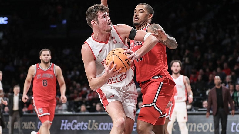 Dec 10, 2023; Brooklyn, New York, USA; Boston College Eagles forward Quinten Post (12) looks to post up against St. John's Red Storm center Joel Soriano (11) in the second half at Barclays Center. Mandatory Credit: Wendell Cruz-USA TODAY Sports