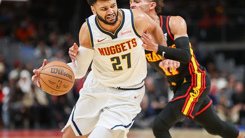 Dec 11, 2023; Atlanta, Georgia, USA; Denver Nuggets guard Jamal Murray (27) is fouled by Atlanta Hawks guard Trae Young (11) in the second quarter at State Farm Arena. Mandatory Credit: Brett Davis-USA TODAY Sports