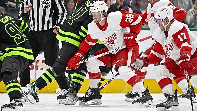 Dec 11, 2023; Dallas, Texas, USA; Dallas Stars center Tyler Seguin (91) and Detroit Red Wings right wing Christian Fischer (36) battle for control of the puck during the first period at the American Airlines Center. Mandatory Credit: Jerome Miron-USA TODAY Sports