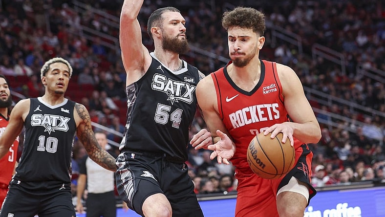 Dec 11, 2023; Houston, Texas, USA; Houston Rockets center Alperen Sengun (28) controls the ball as San Antonio Spurs forward Sandro Mamukelashvili (54) defends during the second quarter at Toyota Center. Mandatory Credit: Troy Taormina-USA TODAY Sports