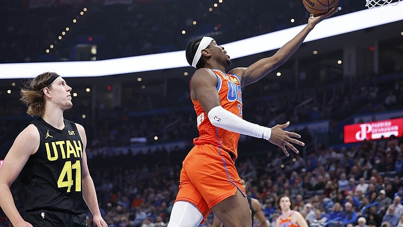 Dec 11, 2023; Oklahoma City, Oklahoma, USA; Oklahoma City Thunder guard Shai Gilgeous-Alexander (2) shoots ahead of Utah Jazz forward Kelly Olynyk (41) during the second quarter at Paycom Center. Mandatory Credit: Alonzo Adams-USA TODAY Sports