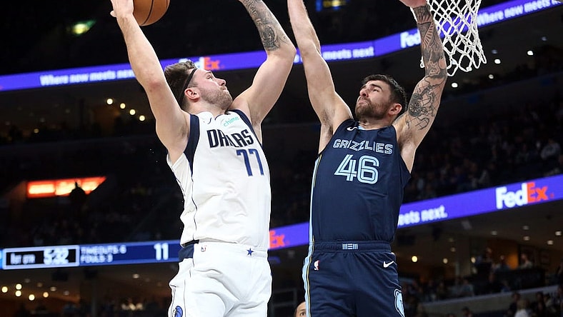 Dec 11, 2023; Memphis, Tennessee, USA; Dallas Mavericks guard Luka Doncic (77) drives to the basket as Memphis Grizzlies guard John Konchar (46) defends during the first half at FedExForum. Mandatory Credit: Petre Thomas-USA TODAY Sports