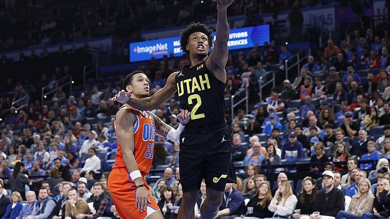 Dec 11, 2023; Oklahoma City, Oklahoma, USA; Utah Jazz guard Collin Sexton (2) shoots in front of Oklahoma City Thunder guard Tre Mann (23) during the second half at Paycom Center. Mandatory Credit: Alonzo Adams-USA TODAY Sports