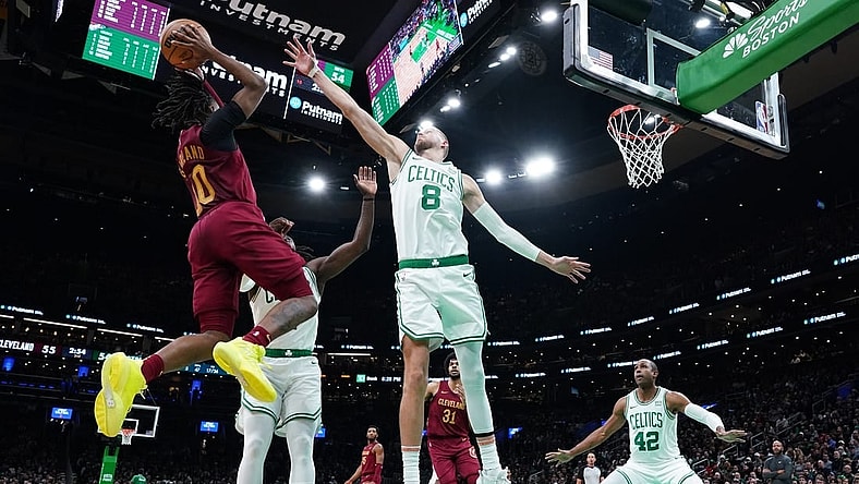 Dec 12, 2023; Boston, Massachusetts, USA; Boston Celtics center Kristaps Porzingis (8) and guard Jrue Holiday (4) defend against Cleveland Cavaliers guard Darius Garland (10) in the second quarter at TD Garden. Mandatory Credit: David Butler II-USA TODAY Sports