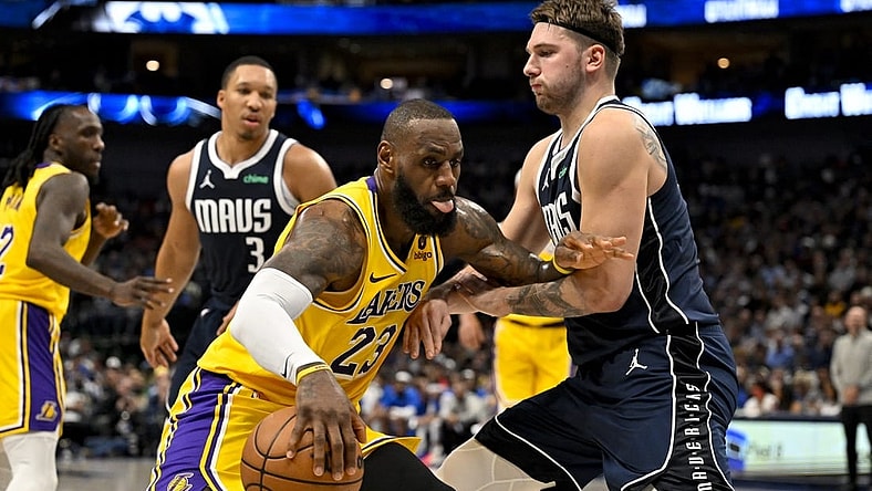 Dec 12, 2023; Dallas, Texas, USA; Los Angeles Lakers forward LeBron James (23) looks to move the ball past Dallas Mavericks guard Luka Doncic (77) during the second quarter at the American Airlines Center. Mandatory Credit: Jerome Miron-USA TODAY Sports
