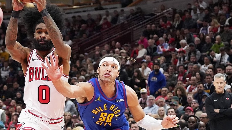 Dec 12, 2023; Chicago, Illinois, USA; Denver Nuggets forward Aaron Gordon (50) defends Chicago Bulls guard Coby White (0) during the first half at United Center. Mandatory Credit: David Banks-USA TODAY Sports