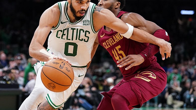 Dec 12, 2023; Boston, Massachusetts, USA; Boston Celtics forward Jayson Tatum (0) drives the ball against Cleveland Cavaliers guard Donovan Mitchell (45) in the second half at TD Garden. Mandatory Credit: David Butler II-USA TODAY Sports