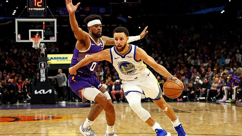 Dec 12, 2023; Phoenix, Arizona, USA; Golden State Warriors guard Stephen Curry (30) drives to the basket against Phoenix Suns guard Jordan Goodwin (0) during the third quarter at Footprint Center. Mandatory Credit: Mark J. Rebilas-USA TODAY Sports