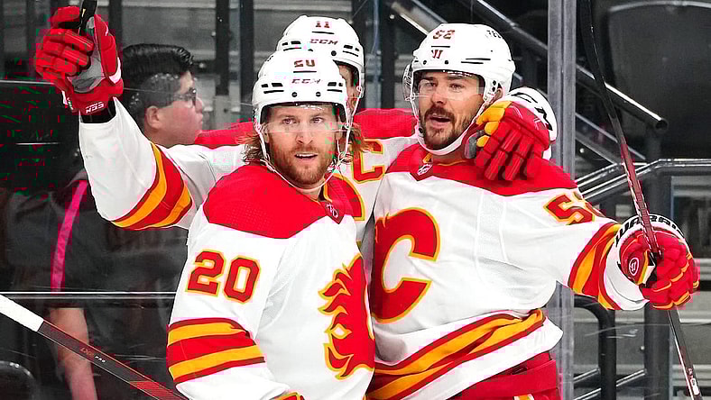 Dec 12, 2023; Las Vegas, Nevada, USA; Calgary Flames defenseman MacKenzie Weegar (52) celebrates with Calgary Flames center Mikael Backlund (11) and Calgary Flames center Blake Coleman (20) after scoring a goal against the Vegas Golden Knights during the first period at T-Mobile Arena. Mandatory Credit: Stephen R. Sylvanie-USA TODAY Sports