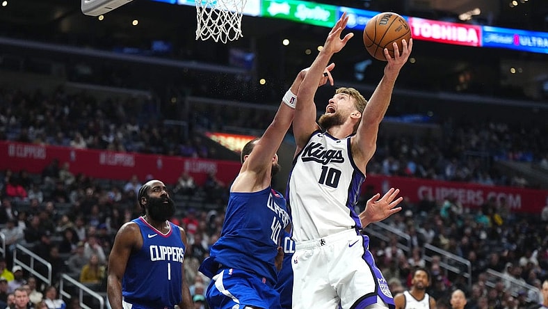 Dec 6, 2023; Los Angeles, California, USA; Sacramento Kings forward Domantas Sabonis (10) shoots the ball against LA Clippers center Ivica Zubac (40) in the second half at Crypto.com Arena. Mandatory Credit: Kirby Lee-USA TODAY Sports