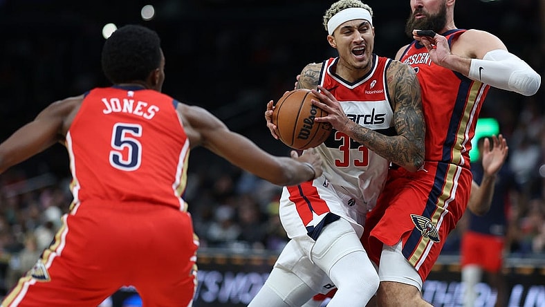 Dec 13, 2023; Washington, District of Columbia, USA; Washington Wizards forward Kyle Kuzma (33) drives to the basket as New Orleans Pelicans center Jonas Valanciunas (17) defends in the second quarter at Capital One Arena. Mandatory Credit: Geoff Burke-USA TODAY Sports