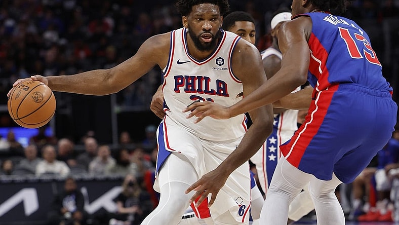 Dec 13, 2023; Detroit, Michigan, USA;  Philadelphia 76ers center Joel Embiid (21) is defended by Detroit Pistons center James Wiseman (13) in the first half at Little Caesars Arena. Mandatory Credit: Rick Osentoski-USA TODAY Sports