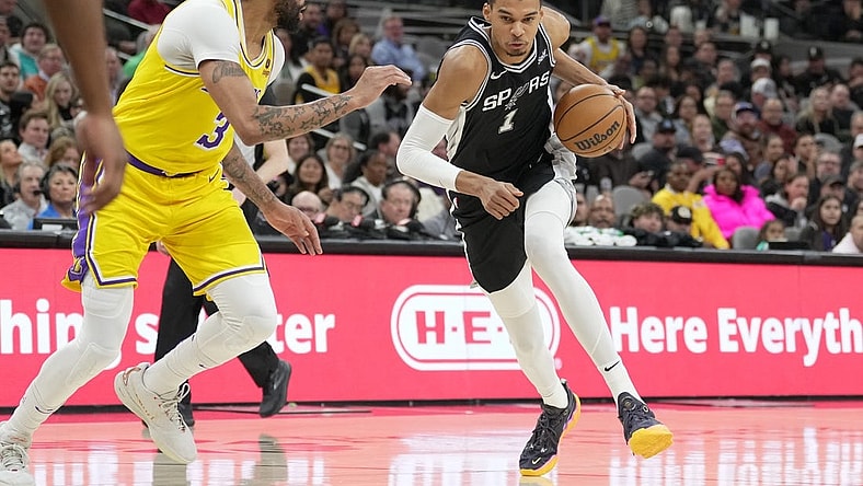 Dec 13, 2023; San Antonio, Texas, USA;  San Antonio Spurs center Victor Wembanyama (1) dribbles against Los Angeles Lakers forward Anthony Davis (3) in the first half at the Frost Bank Center. Mandatory Credit: Daniel Dunn-USA TODAY Sports