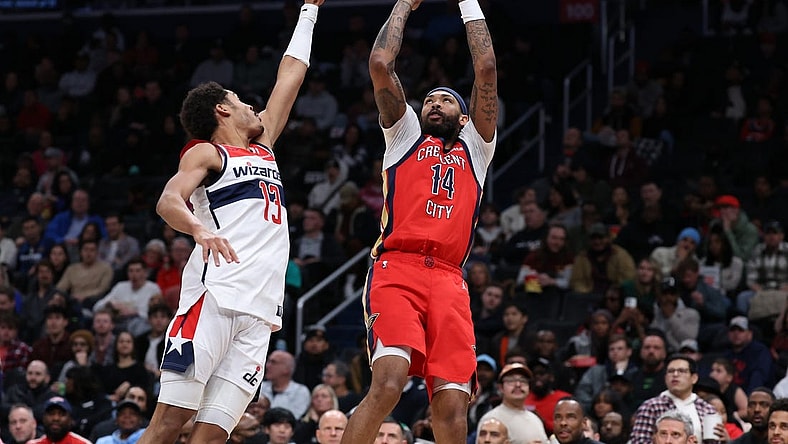 Dec 13, 2023; Washington, District of Columbia, USA; New Orleans Pelicans forward Brandon Ingram (14) shoots the ball over Washington Wizards guard Jordan Poole (13) in the third quarter at Capital One Arena. Mandatory Credit: Geoff Burke-USA TODAY Sports