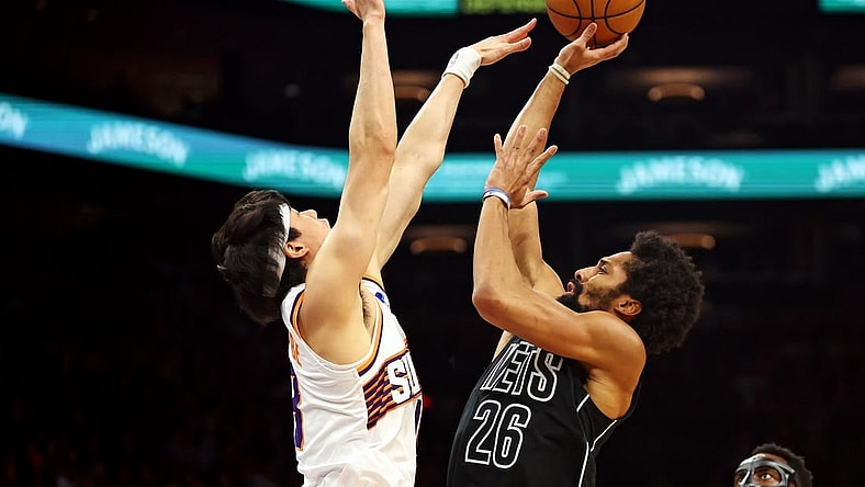 Dec 13, 2023; Phoenix, Arizona, USA; Brooklyn Nets guard Spencer Dinwiddie (26) shoots the ball against Phoenix Suns forward Yuta Watanabe (18) during the second quarter at Footprint Center. Mandatory Credit: Mark J. Rebilas-USA TODAY Sports
