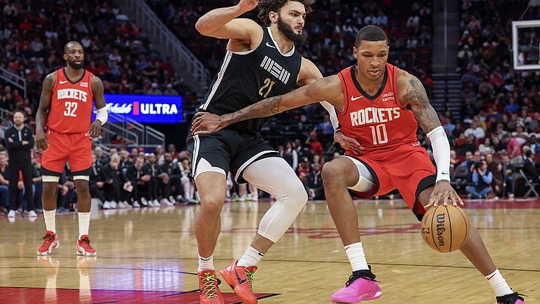 Dec 13, 2023; Houston, Texas, USA; Houston Rockets forward Jabari Smith Jr. (10) dribbles against Memphis Grizzlies forward David Roddy (21) in the second half at Toyota Center. Mandatory Credit: Thomas Shea-USA TODAY Sports