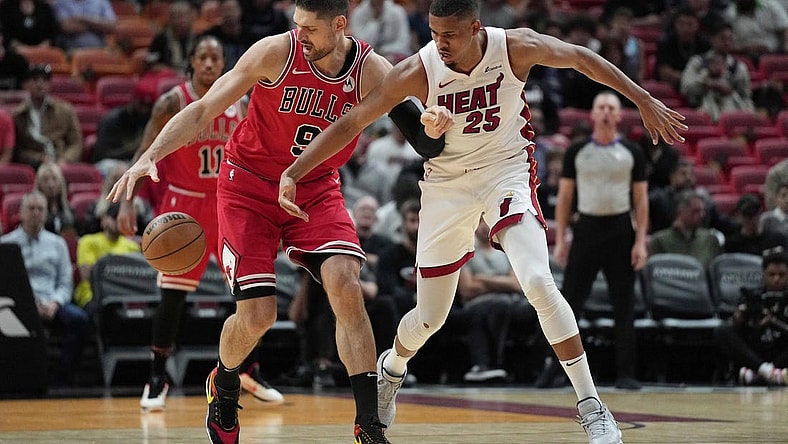 Dec 14, 2023; Miami, Florida, USA; Chicago Bulls center Nikola Vucevic (9) intercepts a pass intended for Miami Heat center Orlando Robinson (25) during the first half at Kaseya Center. Mandatory Credit: Jim Rassol-USA TODAY Sports