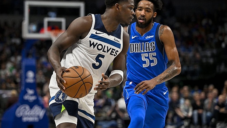 Dec 14, 2023; Dallas, Texas, USA; Minnesota Timberwolves guard Anthony Edwards (5) looks to move the ball past Dallas Mavericks forward Derrick Jones Jr. (55) during the first quarter at the American Airlines Center. Mandatory Credit: Jerome Miron-USA TODAY Sports