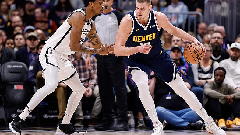 Dec 14, 2023; Denver, Colorado, USA; Denver Nuggets center Nikola Jokic (15) controls the ball as Brooklyn Nets center Nic Claxton (33) guards in the first quarter at Ball Arena. Mandatory Credit: Isaiah J. Downing-USA TODAY Sports