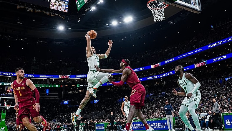 Dec 14, 2023; Boston, Massachusetts, USA; Boston Celtics forward Jayson Tatum (0) drives to the basket against Cleveland Cavaliers guard Caris LeVert (3) in the second half at TD Garden. Mandatory Credit: David Butler II-USA TODAY Sports