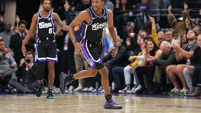 Dec 14, 2023; Sacramento, California, USA; Sacramento Kings guard De'Aaron Fox (5) reacts after making a three point basket against the Oklahoma City Thunder during the fourth quarter at Golden 1 Center. Mandatory Credit: Darren Yamashita-USA TODAY Sports