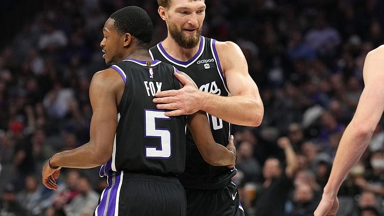 Dec 14, 2023; Sacramento, California, USA; Sacramento Kings guard De'Aaron Fox (5) is congratulated by forward Domantas Sabonis (10) after a basket against the Oklahoma City Thunder during the second quarter at Golden 1 Center. Mandatory Credit: Darren Yamashita-USA TODAY Sports