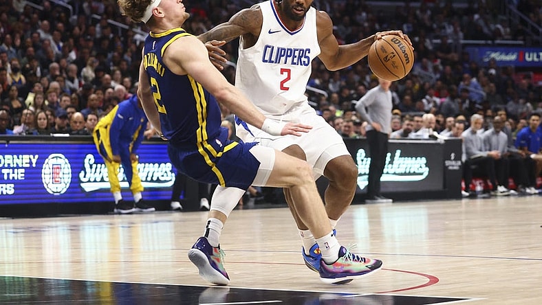 Dec 14, 2023; Los Angeles, California, USA; LA Clippers forward Kawhi Leonard (2) dribbles against Golden State Warriors guard Brandin Podziemski (2) and draws an offensive foul during the second half of the game at Crypto.com Arena. Mandatory Credit: Jessica Alcheh-USA TODAY Sports