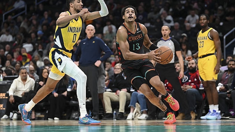Dec 15, 2023; Washington, District of Columbia, USA;Washington Wizards guard Jordan Poole (13) makes a move to the basket by Indiana Pacers guard Tyrese Haliburton (0) during the first half   at Capital One Arena. Mandatory Credit: Tommy Gilligan-USA TODAY Sports