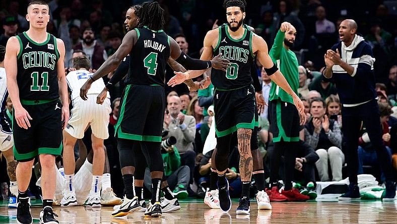Dec 15, 2023; Boston, Massachusetts, USA; Boston Celtics forward Jayson Tatum (0) reacts to his shot with guard Jrue Holiday (4) during the first half against the Orlando Magic at TD Garden. Mandatory Credit: Eric Canha-USA TODAY Sports