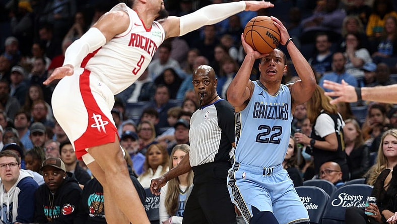 Dec 15, 2023; Memphis, Tennessee, USA; Memphis Grizzlies guard Desmond Bane (22) shoots for three as Houston Rockets  forward Dillon Brooks (9) defends during the first half at FedExForum. Mandatory Credit: Petre Thomas-USA TODAY Sports