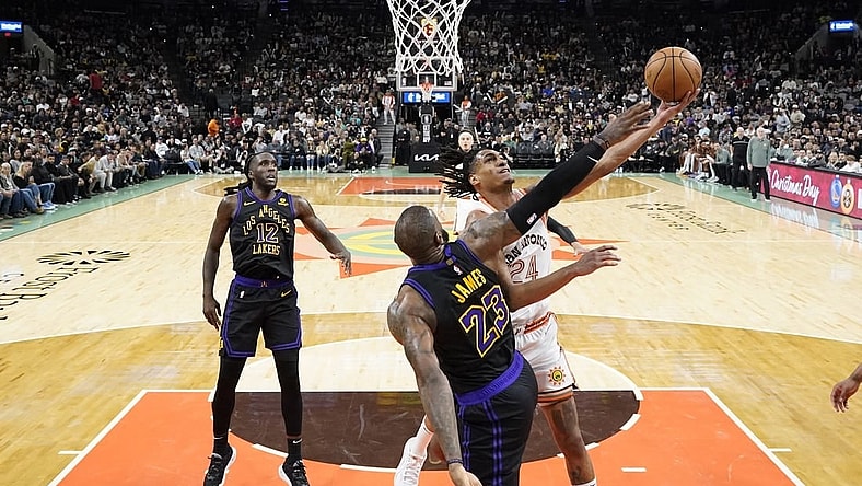 Dec 15, 2023; San Antonio, Texas, USA; San Antonio Spurs guard Devin Vassell (24) drives to the basket against Los Angeles Lakers forward LeBron James (23) during the second half at Frost Bank Center. Mandatory Credit: Scott Wachter-USA TODAY Sports