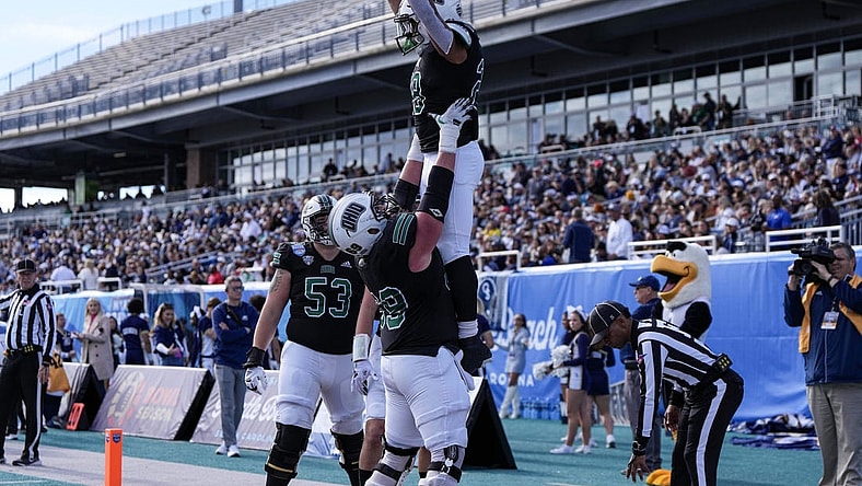 Dec 16, 2023; Conway, SC, USA; Ohio Bobcats running back Rickey Hunt (28) is lifted into the air by Ohio Bobcats offensive lineman Parker Titsworth (69) after a touchdown in the first half against the Georgia Southern Eagles at Brooks Stadium. Mandatory Credit: David Yeazell-USA TODAY Sports