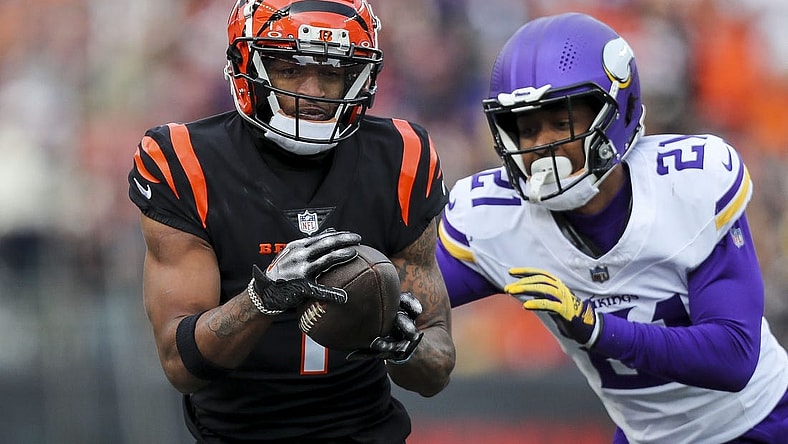 Dec 16, 2023; Cincinnati, Ohio, USA; Cincinnati Bengals wide receiver Ja'Marr Chase (1) runs with the ball against Minnesota Vikings cornerback Akayleb Evans (21) in the first half at Paycor Stadium. Mandatory Credit: Katie Stratman-USA TODAY Sports