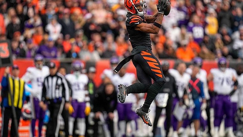 Cincinnati Bengals wide receiver Ja'Marr Chase (1) makes a leaping catch in the fourth quarter of the NFL Week 15 game between the Cincinnati Bengals and the Minnesota Vikings at PayCor Stadium in downtown Cincinnati on Saturday, Dec. 16, 2023. The Bengals won on an overtime field goal.