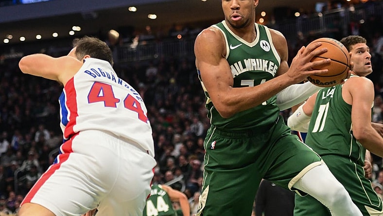 Dec 16, 2023; Milwaukee, Wisconsin, USA; Milwaukee Bucks forward Giannis Antetokounmpo (34) grabs a rebound against Detroit Pistons forward Bojan Bogdanovic (44) in the first quarter at Fiserv Forum. Mandatory Credit: Benny Sieu-USA TODAY Sports