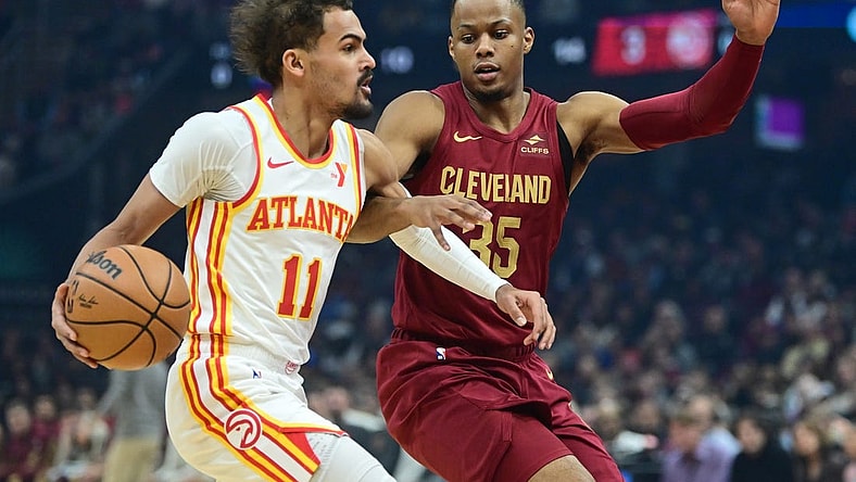 Dec 16, 2023; Cleveland, Ohio, USA; Atlanta Hawks guard Trae Young (11) drives to the basket against Cleveland Cavaliers forward Isaac Okoro (35) during the first quarter at Rocket Mortgage FieldHouse. Mandatory Credit: Ken Blaze-USA TODAY Sports