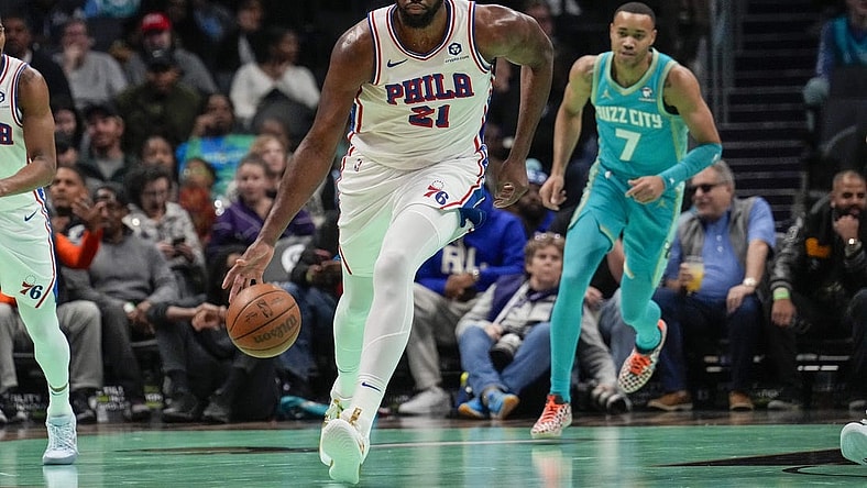 Dec 16, 2023; Charlotte, North Carolina, USA;Philadelphia 76ers center Joel Embiid (21) handles the ball against the Charlotte Hornets during the first quarter at Spectrum Center. Mandatory Credit: Jim Dedmon-USA TODAY Sports