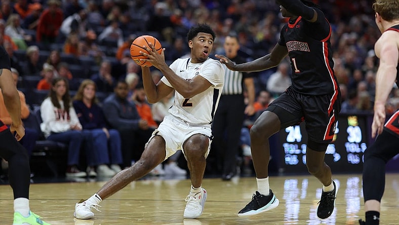 Dec 16, 2023; Charlottesville, Virginia, USA; Virginia Cavaliers guard Reece Beekman (2) holds the ball as Northeastern Huskies guard Masai Troutman (1) defends in the second half at John Paul Jones Arena. Mandatory Credit: Geoff Burke-USA TODAY Sports