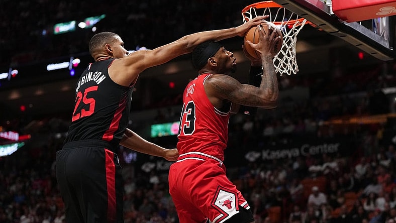 Dec 16, 2023; Miami, Florida, USA; Miami Heat center Orlando Robinson (25) fouls Chicago Bulls forward Torrey Craig (13) during the first half at Kaseya Center. Mandatory Credit: Jasen Vinlove-USA TODAY Sports