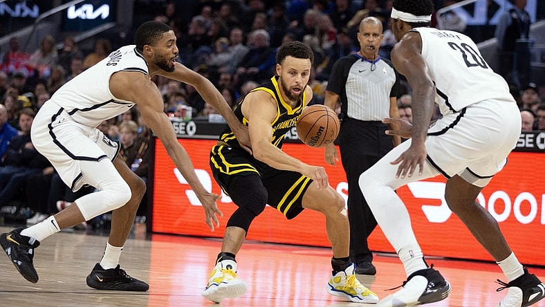 Dec 16, 2023; San Francisco, California, USA; Golden State Warriors guard Stephen Curry (30) controls the ball against Brooklyn Nets guard Mikal Bridges (1) and center Day'Ron Sharpe (20) during the second quarter at Chase Center. Mandatory Credit: D. Ross Cameron-USA TODAY Sports