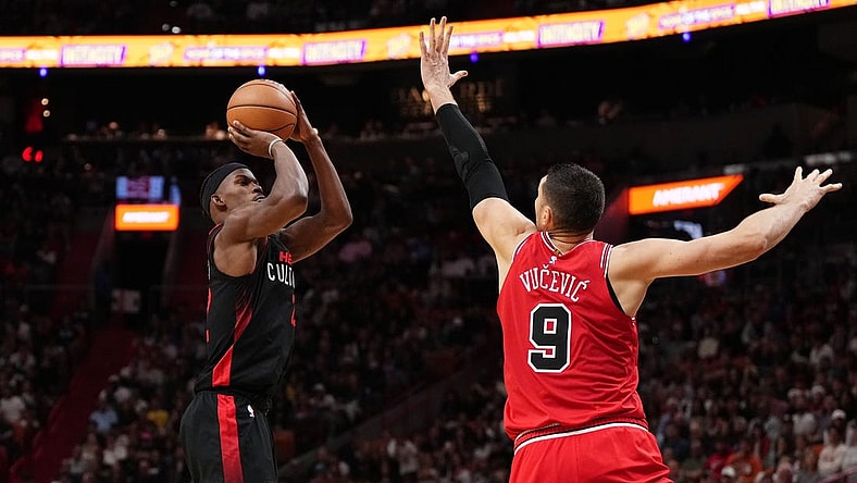 Dec 16, 2023; Miami, Florida, USA; Miami Heat forward Jimmy Butler (22) shoots over Chicago Bulls center Nikola Vucevic (9) during the second half at Kaseya Center. Mandatory Credit: Jasen Vinlove-USA TODAY Sports