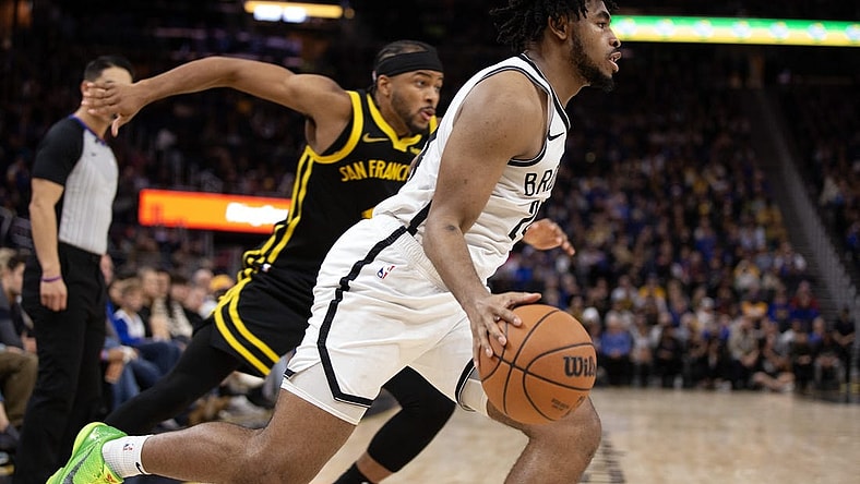 Dec 16, 2023; San Francisco, California, USA; Brooklyn Nets guard Cam Thomas (24) drives the baseline ahead of Golden State Warriors guard Moses Moody (4) during the third quarter at Chase Center. Mandatory Credit: D. Ross Cameron-USA TODAY Sports