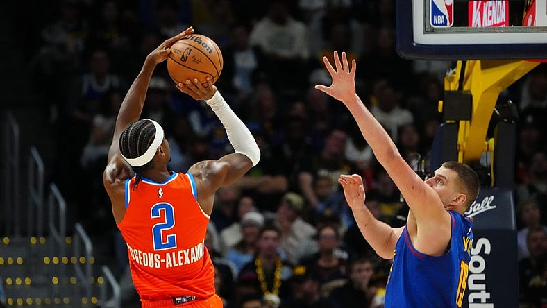 Dec 16, 2023; Denver, Colorado, USA; Oklahoma City Thunder guard Shai Gilgeous-Alexander (2) shoots the ball over Denver Nuggets center Nikola Jokic (15) in the fourth quarter at Ball Arena. Mandatory Credit: Ron Chenoy-USA TODAY Sports