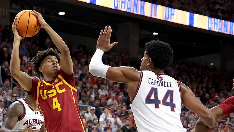 Dec 17, 2023; Auburn, Alabama, USA;  USC Trojans guard Oziyah Sellers (4) looks for a pass as Auburn Tigers center Dylan Cardwell (44) defends during the first half at Neville Arena. Mandatory Credit: John Reed-USA TODAY Sports