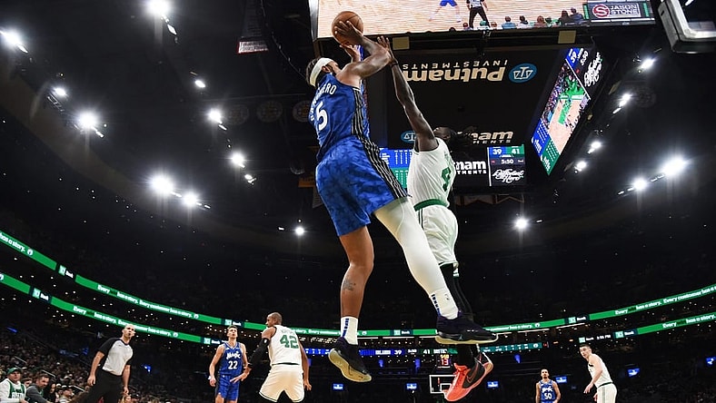 Dec 17, 2023; Boston, Massachusetts, USA;  Orlando Magic forward Paolo Banchero (5) shoots the ball over Boston Celtics guard Jrue Holiday (4) during the first half at TD Garden. Mandatory Credit: Bob DeChiara-USA TODAY Sports