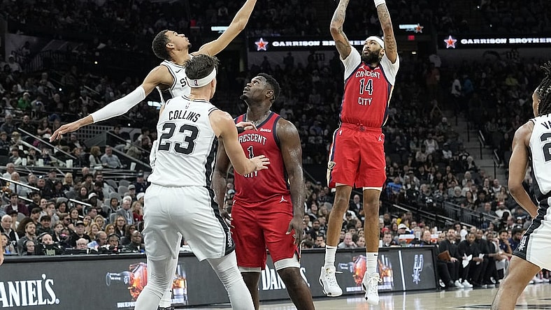Dec 17, 2023; San Antonio, Texas, USA; New Orleans Pelicans Brandon Ingram (14) shoots over San Antonio Spurs forward Victor Wembanyama (1) during the first half at Frost Bank Center. Mandatory Credit: Scott Wachter-USA TODAY Sports