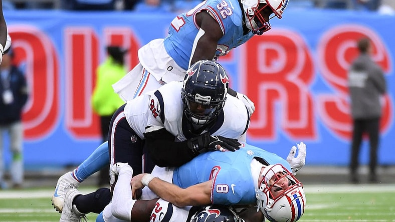 Dec 17, 2023; Nashville, Tennessee, USA; Tennessee Titans quarterback Will Levis (8) is injured after being sacked by Houston Texans cornerback Desmond King II (25) defensive tackle Sheldon Rankins (98) in overtime at Nissan Stadium. Mandatory Credit: Christopher Hanewinckel-USA TODAY Sports