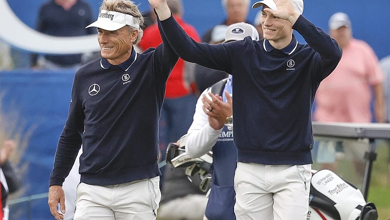 Dec 17, 2023; Orlando, Florida, USA;  Bernhard Langer (left) and his son Jason Langer react to the crowd after they are announced walking onto the 18th green at the PNC Championship at The Ritz-Carlton Golf Club. Mandatory Credit: Reinhold Matay-USA TODAY Sports
