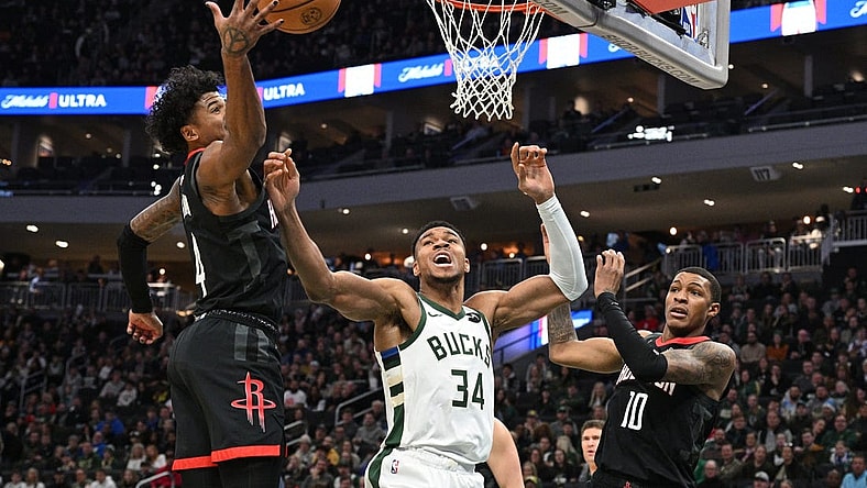 Dec 17, 2023; Milwaukee, Wisconsin, USA; Milwaukee Bucks forward Giannis Antetokounmpo (34) battles for a rebound with Houston Rockets guard Jalen Green (4) in the first half at Fiserv Forum. Mandatory Credit: Michael McLoone-USA TODAY Sports